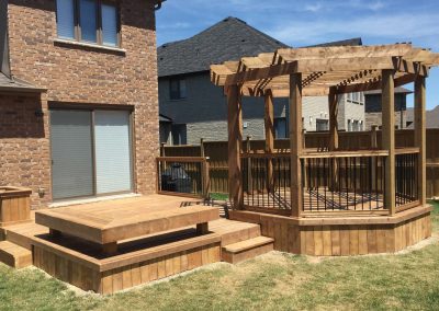 Custom residential backyard wooden deck design with pergola