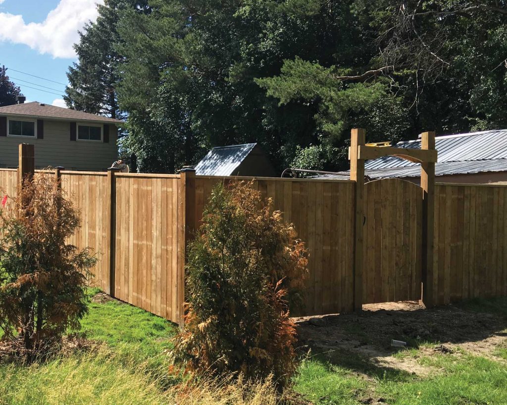 Residential backyard with a wooden fence and gate