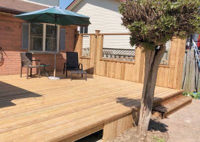 Custom wooden deck designed in the backyard of a home